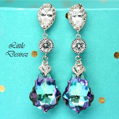 "These gorgeous and timeless Swarovski Vitrail Light Earrings have a Victorian touch of elegance and romance. The baroque pendants have classic scroll-shaped silhouettes and are precision beveled/faceted to enhance the color and characteristic of the crystal, making each piece a glistening treasure! Perfect for brides, bridesmaids and special occasions! Earrings made with: - 22mm GENUINE Swarovski Vitrail Light Baroque crystals. The crystals emit so much shine and sparkle as it changes colors at Elegant Lavender Crystal Earrings For Party, Purple Crystal Earrings For Wedding, Elegant Purple Clip-on Earrings For Formal Occasions, Elegant Lavender Earrings For Party, Purple Bridal Earrings With Matching Set, Purple Drop Chandelier Earrings For Formal Occasions, Elegant Purple Drop Crystal Earrings, Lavender Drop Earrings For Party, Elegant Purple Cubic Zirconia Crystal Earrings