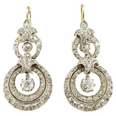 This magnificent pair of Diamond drop earrings are Victorian era, 1870 circa Hand crafted during the time of solid 18 KT gold silver topped They articulate into a distinctive circular shape displaying fine workmanship loaded with opulence of bright white old mine cut Diamonds adding charming sparkle throughout the glorious workmanship Diamonds are 4 cushion old mine cut totaling approx 1.40 Ct (H/I-VS/SI) - 142 old mine cut Diamonds totaling approx 4.60 Ct (H/I-VVS/SI)– TCW approx 6.00 They will Silver Tops, Diamond Drops, Diamond Drop Earrings, Victorian Era, Jewelry Earrings Dangle, Silver Gold, Diamond Cuts, Hand Crafted, Dangle Earrings