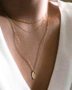 "This delicate pendant necklace is a classic, easy to gift piece. From the chain to the pendant, this style is made with 14k gold filled or sterling silver pieces, meaning it is built to last. Personalize this necklace with the names, dates, and special words that mean the most to you!  𝗘𝗮𝘀𝘆 𝗧𝗼 𝗦𝘁𝘆𝗹𝗲, 𝗠𝗮𝗱𝗲 𝗧𝗼 𝗟𝗮𝘀𝘁 Our classic oval charm necklaces are easy to layer, elegant, and ready to be personalized with your most special sentiments, moments, and memories! Created to last Stone Well, Oval Pendant Necklace, Silver Coin Necklace, Aventurine Necklace, Custom Initial Necklace, Initial Necklace Gold, Charm Necklaces, Choker Style, Disc Necklace