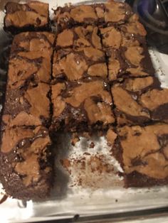 chocolate brownies cut into squares on top of a baking sheet in the oven, ready to be eaten