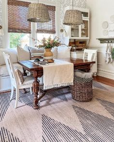 a dining room table with two chairs and a bench