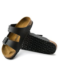 Birkenstock Arizona Black Sandals. The BIRKENSTOCK Arizona is a genuine classic that has been delighting both men and women for decades. This simple sandal with two straps stands for timeless design and has long held cult status thanks to its comfort factor. The upper is made from the skin-friendly, hard-wearing synthetic material Birko-Flor®. Footbed is made with a sustainable cork material extracted from the bark layer of the cork oak. This natural product is insulating and offers very good cu Black Footbed Sandals With Cork-bed Midsoles For Outdoor, Birkenstock Flip Flops, Birkenstock Sandals Arizona, Simple Sandals, Birkenstock Women, Hiking Sandals, Birkenstock Arizona, Clogs Shoes, Comfortable Sandals