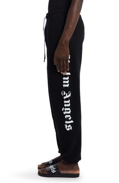 The Milanese label’s Gothic logo boldly brands one side of cotton French terry sweatpants that are equally comfy and street-savvy. 31" inseam; 11" leg opening; 14" front rise; 18" back rise (size Medium) Elastic/drawstring waist Side welt pockets; back welt pocket 100% cotton Hand wash, dry flat Made in Portugal New Concepts @Nordstrom Black Joggers With Logo Waistband For Streetwear, Cotton Bottoms With Logo For Loungewear, Relaxed Fit Bottoms With Logo Waistband For Streetwear, Black Logo Sweatpants For Loungewear, Black Joggers With Logo For Loungewear, Black Sweatpants With Logo Detail For Loungewear, Black Loungewear Joggers With Logo Detail, Black Sweatpants With Logo Print For Loungewear, Sporty Logo Sweatpants For Streetwear