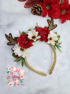 the headband is decorated with red flowers and gold antlers