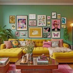 a living room filled with furniture and pictures on the wall