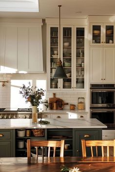 a kitchen filled with lots of counter top space and wooden chairs in front of it