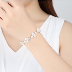 Gorgeous natural real pearl floral leaf diamond crystal wedding bridal bridesmaids bracelet, super sparkly and stunning. Handmade of top quality natural ivory pearls, AAA diamond CZ, and 925 sterling silver. 17cm length, 1.5 cm width, with exquisite buckle closure. Delicate elegant bracelet looks perfect as wedding bridal bridesmaid jewelry, or just as everyday high end accessories. Beautiful shimmery last for years, best quality guaranteed. 💎 Features: ♥ Material: Real gold plated 925 sterling silver ♥ Main stone: Top quality natural freshwater ivory pearls ♥ Side Stone: Cz crystal 💎 Details: ♥ Approximate Measurements: - Length: 17 cm - Width: 1.5 cm ♥ Lightweight, easy to wear ♥ Nickel/Lead Free, Hypoallergenic, good for sensitive skins 🎁 Packing & Shipping: ♥ All our jewelry will be Elegant Flower Bracelets For Formal Occasions, Elegant Crystal Chain Bracelet For Gift, White Cubic Zirconia Bridal Accessories For Wedding, Adjustable Flower-shaped Pearl Jewelry, Elegant Bracelet With Sparkling Stones, Elegant Sparkling Bracelets For Anniversary, Wedding Pearl White Beaded Bracelets, Wedding Pearl Chain Bangle Bracelets, Pearl Chain Bracelet For Wedding