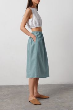 "ELLE is a casual linen midi skirt. DETAILS - Midi length - Elastic waist - 100% lightweight European linen fabric - Cut and sewn to order just for you in our studio COLOR - Dark Turqouise, you can also choose other colors above SIZING & FIT - Fits true to size - Model is 5'9.5\" / 177cm, wearing a size XS CARE FOR LINEN - Machine wash up to 30ºC/86ºF gentle cycle - Lay flat to dry or tumble dry low - Warm iron if needed - Do not bleach SIZE GUIDE Size conversion guide Size XS (US 0-2, IT 36-38, UK 4-6, Japan 3-5, France 32-34) Size S (US 4-6, IT 40-42, UK 8-10, Japan 7-9, France 36-38) Size M (US 8-10, IT 44-46, UK 12-14, Japan 11-13, France 40-42) Size L (US 12-14, IT 48-50, UK 16-18, Japan 15-17, France 44-46) Size XL (US 16-18, IT 52, UK 20-22, Japan 19, France 48) Body measurements gu Cotton Midi Skirt Outfit Summer, Summer Linen Midi-length Bottoms, Casual Linen Midi Bottoms, Summer Bottoms With Pockets, Midi Length, Casual Linen Maxi Skirt, Casual Linen Skirt, Knee-length Linen Bottoms For Spring, Chic Linen Midi-length Bottoms, Summer Linen Skirt With Elastic Waistband