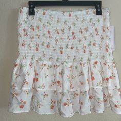 Brand New Skirt Or Top. This Is So Cute And Sweet! This Can Be Worn As A Skirt Or A Top. I Have Another One Very Similar In Color Mine Is Also White But Has More Green This Has More Peach. They Are Flowers With Peach And A Little But Of Yellow And And Bluish Green. It Is Adorable On And Like I Said Cute Both Ways. Tags Are Still Attached. I Love My Other One So Much I Didn’t Know If I Wanted To Sale But The One I Have Is Almost Identical. Looks Cute With Dr. Martens If You Want To Wear In Fall. Summer Mini Skirt With Elastic Waistband For Spring, Cute Flowy Skirt For Summer, Cute Flowy Skirt For Spring, Cute White Tiered Skirt, Cute Fitted Floral Print Skirt, Stretch Mini Skirt For Summer Brunch, Cute White Skirted Bottoms, Cute Skirt For Spring Day Out, Casual Stretch Mini Skirt For Brunch