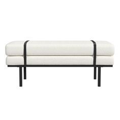 a white bench with black metal legs on a white background and the seat is upholstered