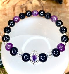 Protective bracelet made by hand in semi-precious stones (amethysts, onyx and crystal aura angel). Silver plated spacers. Soothing and protective, it will act to repel negative energies, dissolve bad thoughts and bring a little light and purity. Each piece being made individually for orders, there may be color variations due to the uniqueness of the stone. Do not hesitate to join us on our facebook page or Instagram "Desarwen" to view the videos of our shop from La Rochelle, and all of our wonde Black Amethyst 8mm Bead Bracelets, Black Amethyst Bracelets With 8mm Beads, Spiritual Healing Crystal Bracelet With Spacer Beads, Black Amethyst Bracelet With 8mm Beads, Spiritual Amethyst Crystal Bracelet, Black Amethyst Beaded Bracelets Spiritual, Spiritual Black Amethyst Beaded Bracelets, Spiritual Purple Crystal Bracelet With Spacer Beads, Black Amethyst Gemstone Bracelets