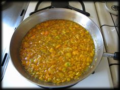 a pot filled with food sitting on top of a stove