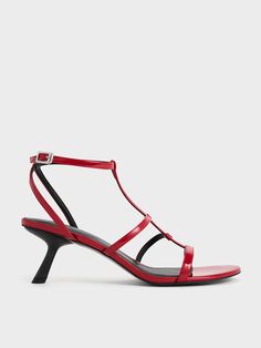 Even the slightest heel can make a significant difference to your posture. Elevate both your style and stature with these Clara asymmetric T-bar sandals. They feature a classic T-bar design with a contemporary twist -- additional straps create a stylish cage-like effect that lends a cool edge to the elegant design. The glossy red finish adds a sensual appeal and will infuse your outfit with a touch of fierce elegance Pu Heels, Charles Keith, Shoe Gifts, Ankle Straps, Bar Design, Clothes Gift, Trending Shoes, Elegant Design, Heel Height