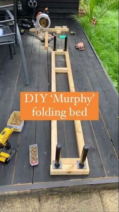 the diy'murphy folding bed is made out of wood and has tools on it