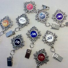 a bunch of different types of key chains on a white surface with the letters w and j in them