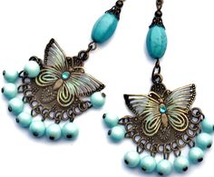 "Flirty chandelier earrings featuring filigree butterfly accents on embossed antiqued pendants that swing over dangling pale turquoise blue glass beads! Each of the butterflies are accented with painted touches of sea foam green & turquoise and little Swarovski crystal rhinestones sparkle in their centers! Each unique pendant dangles from genuine magnesite beads, too, which are thought to aid in meditation and creativity! Just dangle this unique pair from your ears to add fun, Boho style to Bohemian Butterfly Charm Jewelry For Jewelry Making, Bohemian Jewelry With Butterfly Charm For Jewelry Making, Bohemian Dangle Jewelry With Butterfly Charm, Bohemian Jewelry With Butterfly Charm Dangle, Bohemian Butterfly Jewelry With Pierced Design, Dangle Bead Earrings, Butterfly Boho, Blue Choker Necklace, Silver Bead Earrings