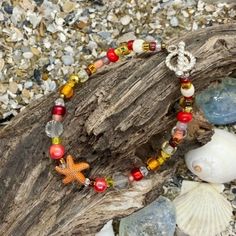 Colorful boho bracelet with an orange metal starfish focal bead, accented with a variety of smaller beads in orange/red colors. Bracelet is 6.5 inches long - please let me know if you need a different length and I will adjust it Starfish Shaped Beaded Bracelets For Beach, Colorful Beads Starfish Bracelet For Beach, Colorful Beaded Starfish Bracelets For Beach, Colorful Starfish Beaded Bracelets For Beach, Coral Beaded Bracelets For The Beach, Coral Beaded Bracelets For Beach, Coral Beaded Beach Bracelets, Orange Beach Bracelets With Spacer Beads, Bohemian Beaded Bracelet With Starfish For Beach Season