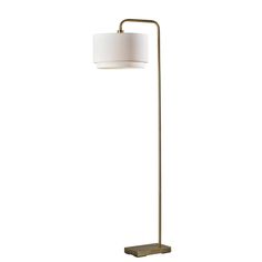 a floor lamp with a white shade on the base and a gold metal frame around it