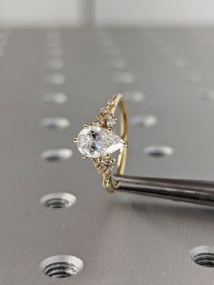 a diamond ring sitting on top of a metal surface