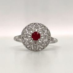 Exquisite Round Halo Ring With Gemstone, Exquisite Halo Ring With Gemstone, Exquisite Ruby Ring With Center Stone, Luxury Rings With Intricate Design, Art Deco Halo Ring With Center Stone, Exquisite Ruby Gemstone Ring, Art Deco Round Halo Ring With Center Stone, Fine Jewelry Rose Cut Diamond Flower Ring, Ruby Cluster Ring With Rose Cut Diamonds