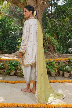 This intricately embroidered self jamawar kurta is a season favourite. The brightly embroidered florals offset the cream base. The shawl is beautifully worked with a mix of florals with a linear pattern. The look is completed with a rawsilk izaar that is finished with worked borders. Eid Embroidered Slub Silk Sherwani, Embroidered Slub Silk Sherwani For Eid, Traditional Embroidered Slub Silk Sherwani, Embroidered Slub Silk Sherwani With Traditional Drape, Traditional Tussar Silk Sherwani With Resham Embroidery, Traditional Chanderi Sherwani With Naqshi, Wedding Sherwani In Embroidered Slub Silk, Off White Naqshi Traditional Wear For Festive Occasions, Sherwani With Intricate Embroidery In Cotton Silk