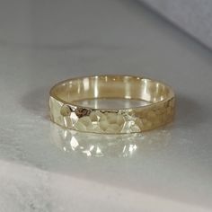 a close up of a gold ring on a white surface