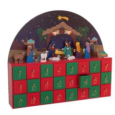 a red and green wooden christmas scene with nativity scene on it's side