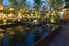 an outdoor dining area with tables and water features