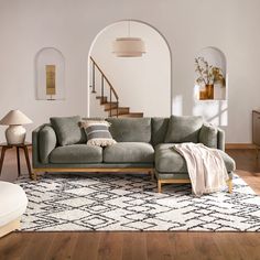 a living room filled with furniture and a rug