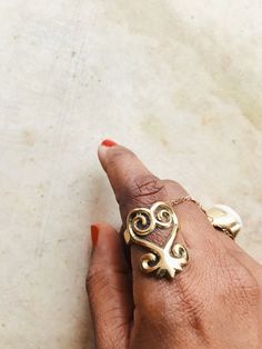 "A beautiful solid brass Sankofa Ring. The Sankofa symbolizes learning from your past, so that you may move on in the future (to go back and get it). DETAILS: 1\" Sankofa Solid brass band(not adjustable) Ships with sample polishing cloth ((Listing is for Sankofa Ring only, all other rings are sold separately.)) Return to shop: Afrohemien.etsy.com Like and Follow Afrohemien for updates, sales, coupons and surprise giveaways Instagram/Blog: instagram.com/Afrohemien Tumblr: Afrohemien.tumblr.com Fa Traditional Hand Forged Rings As Gift, Adjustable Brass Rings For Ceremonial Occasions, Hand Forged Brass Rings With Spiritual Style, Symbolic Brass Jewelry For Promise, Spiritual Hand Forged Brass Rings, Unique Engraved Brass Rings, Engraved Brass Rings, Bohemian Gold Rings With Intricate Design, Brass Promise Rings