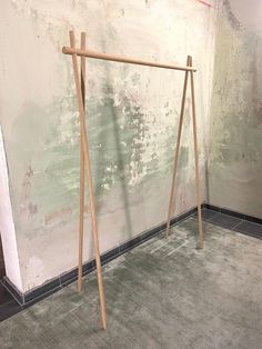 a wooden frame leaning against a wall in an empty room with no one on it