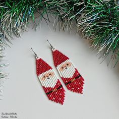 santa claus beaded earrings hanging from a christmas tree