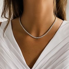 Compliment any look with Alexandra’s stunning and truly timeless, classic prong set CZ Tennis Necklace. Set in fine sterling silver, it’s the one necklace that can be both fancy and casual at the same time. From your big day to everyday, a tennis necklace brightens up any look. Details:• Round Brilliant Cubic Zirconia Stones• Rhodium Plated Sterling Silver • Length: 16" • Safety Clasp • Stone Size: from 4mm Bridal Tennis Necklace, Silver Tennis Necklace, Big Silver Necklace, Tennis Necklace Diamond, Diamond Necklace Gift, Diamond Tennis Necklace, Necklace Everyday, Bridal Jewelry Collection, Hot Jewelry