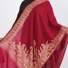 Our new Durga Embroidered Shawl features exquisite embroidery on soft 100% merino wool. With a stunning paisley design, this classically beautiful shawl showcases the intricate embroidery traditions of Northern India in rich gold tones on a burgundy red base. The high quality and elegance of these embroidered shawls make them treasures that will last for generations. Elegant Pashmina Shawl With Zari Work In Jamawar, Elegant Pashmina Shawl With Traditional Drape For Festivals, Elegant Pashmina Dupatta With Zari Work, Elegant Embroidered Pashmina Shawl For Festivals, Elegant Embroidered Shawl Traditional Wear, Elegant Jamawar Pashmina Shawl With Zari Work, Elegant Pashmina Shawl With Zari Work, Traditional Pashmina Shawl For Formal Occasions, Elegant Pashmina Shawl With Intricate Embroidery For Festivals