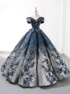 This ball gown by Kemedress is the epitome of winter wonderland luxury. It features thousands of deep blue and silver sequins that sit alongside textured blue floral appliques to create the look of a royal princess. The sweetheart neckline is accentuated by a dramatic off-the-shoulder cut for an amazing fit. Wedding Dress Trumpet, डिजाइनर कपड��़े, Sequin Ball Gown, Vintage Ball Gowns, Sweet 15 Dresses, Floor Length Wedding Dress, Blue Ball Gowns, Floral Prom Dresses, Lace Ball Gowns