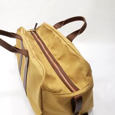 "This Travel Bag is made from 18 oz harvest tan canvas with brown leather trims. SIZE: 20\" wide x 13\" Tall x 11\" depth Features: 2\" adjustable cross bodyt strap (Removable) 2 sides handles Inside zipper pocket 9\"x10\" Metal tooth zipper for long lasting use Stitched with nylon tread for durability. ♡ PROCESSING TIME: Your travel bag will ship within 1-3 business day after purchase. ♡ SHIPPING TIME: 2-5 business days within the US via UPS. ♡ GIFTS: You can ship our products directly to your Khaki Canvas Travel Bag, Khaki Canvas Bag For Travel, Canvas Shoulder Bag With Leather Handles For Overnight Trips, Brown Waxed Canvas Duffle Bag For Travel, Travel Duffle Bag In Khaki Canvas, Khaki Duck Canvas Bag With Canvas Lining, Beige Duck Canvas Bag With Canvas Lining, Brown Waxed Canvas Weekender Bag With Large Capacity, Rectangular Canvas Duffle Bag With Leather Trim