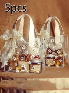 three clear bags filled with different types of items on top of a wooden table next to each other