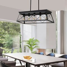 a dining room table with chairs and a light fixture hanging from it's ceiling