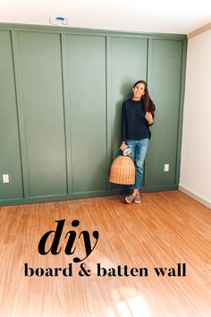 a woman leaning against a wall with a basket in her hand and the words diy board & batten wall