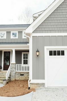 a gray house with white trim and windows