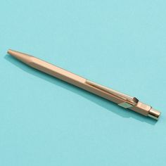 a pen sitting on top of a blue surface