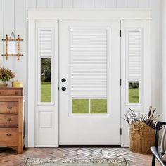 a white front door with blinds on the side and an area rug in front of it