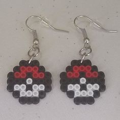 a pair of earrings made out of legos