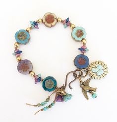 a bracelet with flowers and charms on it