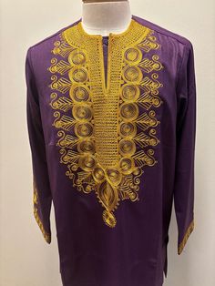 African Purple men top with gold embroidery This is a long sleeve shirt, but please indicate if you wanted in a short sleeves Festive Long Sleeve Embroidered Shirt, Festive Long Sleeve Shirt With Floral Embroidery, Festive Long-sleeve Shirt With Floral Embroidery, Fitted Long Sleeve Embroidered T-shirt, Traditional Long Sleeve Shirt For Festive Occasions, Gold Long Sleeve Cotton Shirt, Traditional Long Sleeve Shirt For Eid, Long Sleeve Kurta With Gold Embroidery For Eid, Traditional Long Sleeve Festive Shirt