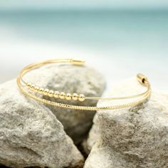 This beautiful double-strand bracelet is lightweight, bendable, and shiny, making it comfortable to wear. It is gold-plated, ensuring it maintains its stunning shine, especially when kept away from water. This bracelet is perfect for complementing our tile bracelets, but it also makes a great statement piece on its own. Gold Bracelet Cuff, Gold Cuffs, Strand Bracelet, Wear It, Cuff Bracelet, Statement Pieces, Tile, Gold Plate, Plating