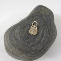 This adorable charm is entirely hand-crafted from recycled 14k gold, which I melt down and form into this petite, organic little pendant. It is then hand-stamped with two sweet leaves and is finished with a genuine flush set diamond. Available with either a shiny gold or satin finish. Includes an open jumpring for hanging. It will be your favorite new spring necklace! *This listing is for one Diamond Petal Charm only. Chain not included and shown with other charms for layering options. :: Solid Dainty Yellow Gold Charms With Birthstone, Dainty Yellow Gold Birthstone Charms, Personalized Pendant Charm Necklace In Recycled Gold, Delicate Recycled Gold Pendant Charm Necklace, Yellow Gold Charm Necklace In Recycled Gold, Minimalist 14k Gold Pendant Charm, Dainty 14k Gold Charm Necklace With Flower Charm, Minimalist 14k Yellow Gold Charms, Nickel-free 14k Yellow Gold Charm Necklace