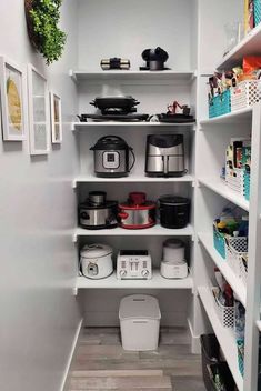 an organized pantry with white shelving and shelves