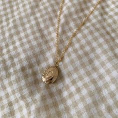 Our precious Isabella Mini Locket! <3 A great personalized gift for your friends, family, or loved ones! <3 These dainty and lightweight necklaces are the perfect necklaces to wear everyday! -----DESCRIPTION----- ✳16k Gold plated necklace chain OVAL LOCKET CHARM ✳14k Gold Plated ✳Size: 10x12mm ✳WATER RESISTANT! -----SIZING----- ✳16.5" necklace chain -----JEWELRY CARE----- ✳Avoid getting wet! ✳Avoid direct contact with perfume. ✳Remove before sleeping. ✳Store in a cool dry place. ✳For light cleaning, gently polish with a soft, lint-free cloth to avoid scratching and tarnish. Minimalist Oval Pendant Necklaces For Mother's Day, Delicate Charm Necklace With Oval Pendant And Adjustable Chain, Delicate Charm Necklace With Oval Pendant, Minimalist Oval Pendant Necklace For Mother's Day, Dainty Initial Pendant Locket Necklace As Gift, Dainty Locket Necklace With Initial Pendant As Gift, Vintage Gold Necklace For Mom, Delicate Oval Pendant Necklace For Gifts, Dainty Locket Necklace For Everyday