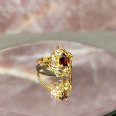 Step back in time with our exquisite Vintage 10k Gold Freeform Ring, featuring a mesmerizing Pear Cut Garnet. This timeless piece of fine jewelry exudes elegance and charm, perfect for adding a touch of vintage glamour to any ensemble. Crafted with care and attention to detail, this ring boasts a unique freeform design that sets it apart from the ordinary. The lustrous 10k gold band adds a luxurious touch, while the pear-cut garnet gemstone sparkles with rich hues of red, reminiscent of a deep s Luxury Topaz Birthstone Ring For Formal Occasions, 14k Yellow Gold Pear-shaped Birthstone Ring, Formal Luxury Topaz Birthstone Ring, Pear-shaped 14k Yellow Gold Birthstone Ring, Elegant Pear-shaped Yellow Gold Birthstone Ring, Pear-shaped Yellow Gold Birthstone Ring, Gold Marquise Ruby Ring For Gift, Formal Fine Jewelry Birthstone Ring With Polished Finish, Marquise Yellow Gold 14k Birthstone Ring